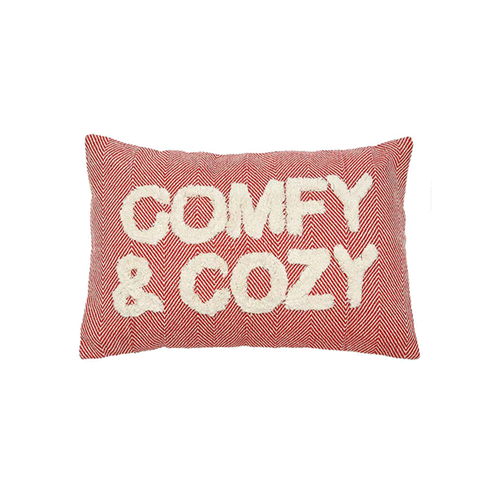 A light red pillow that says Comfy and Cozy.